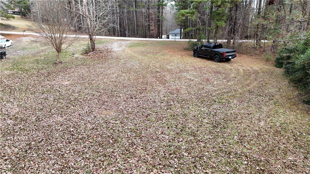 7307 Williams Road Flowery Branch, GA 30542 - Photo 16 of 30 a view of backyard with parked car