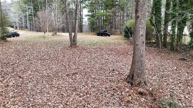 a view of backyard with table and chairs