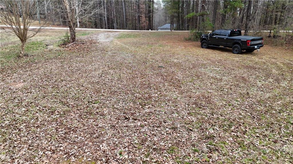 7307 Williams Road Flowery Branch, GA 30542 - Photo 21 of 30 a view of backyard with table and chairs