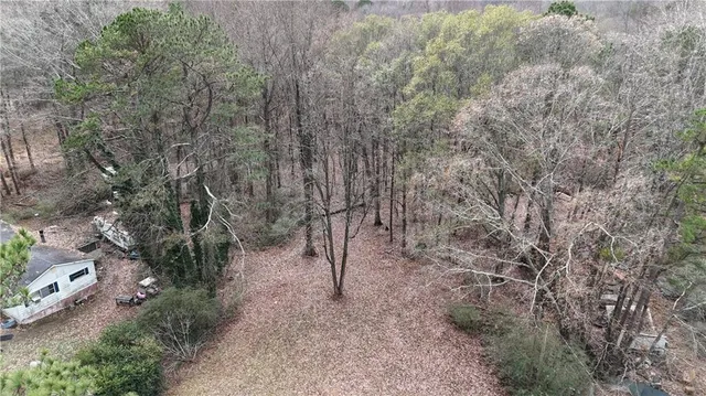 a backyard of a house with lots of green space and trees
