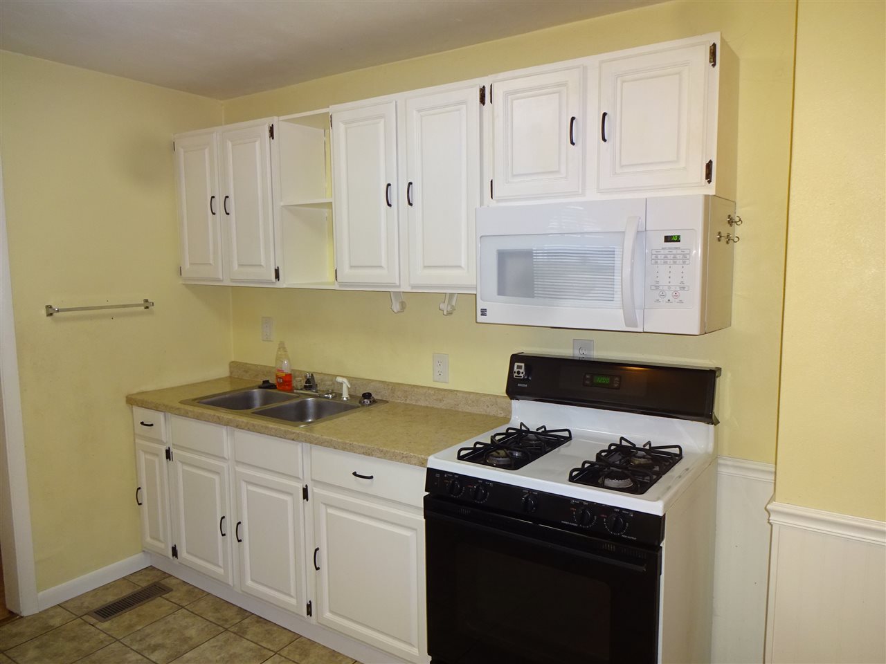 7707 Randy Road Machesney Park, IL 61115 - Photo 6 of 17 a kitchen with granite countertop white cabinets and white appliances