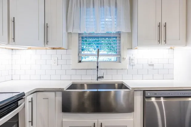 a kitchen with a sink cabinets and window