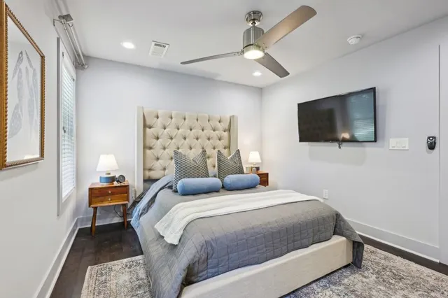 a bedroom with a bed and a flat screen tv