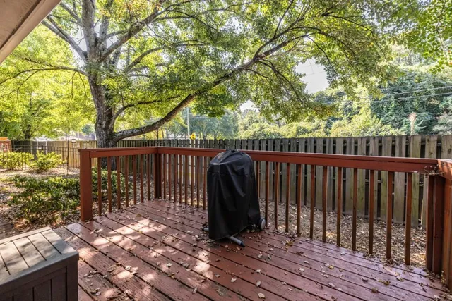a view of balcony with wooden floor and fence