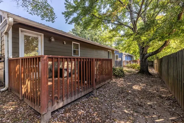 a view of a house with wooden fence