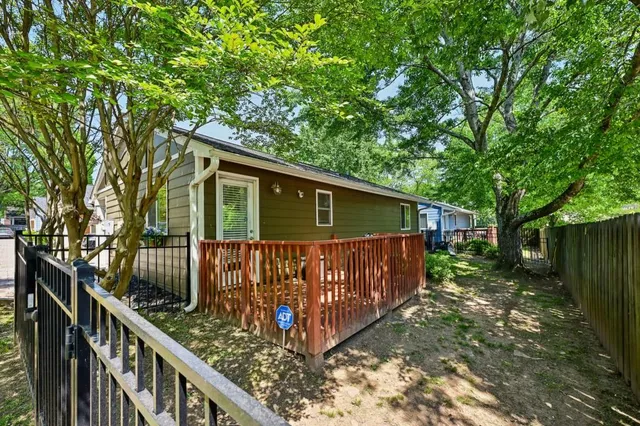 a view of backyard with deck and outdoor seating