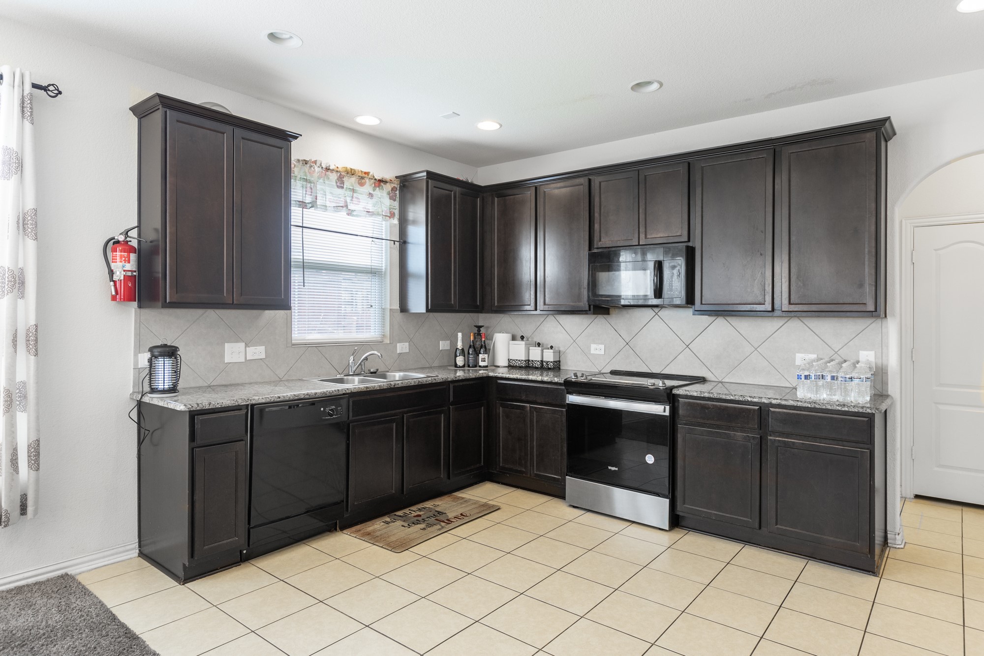 263 Joseph Drive Buda, TX 78610 - Photo 11 of 27 a kitchen with stainless steel appliances granite countertop a sink and cabinets