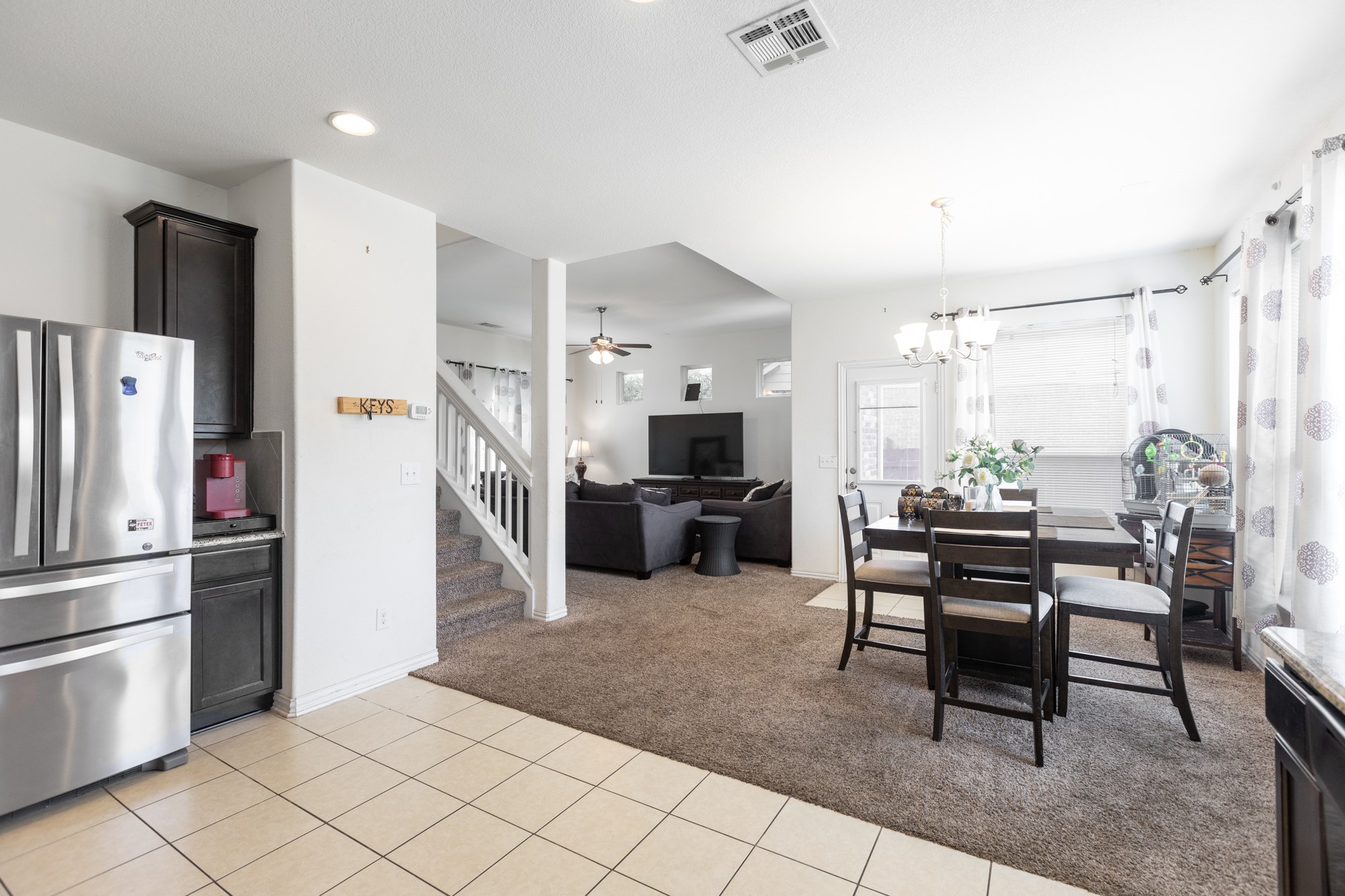263 Joseph Drive Buda, TX 78610 - Photo 13 of 27 a kitchen with stainless steel appliances kitchen island granite countertop a refrigerator and a stove top oven