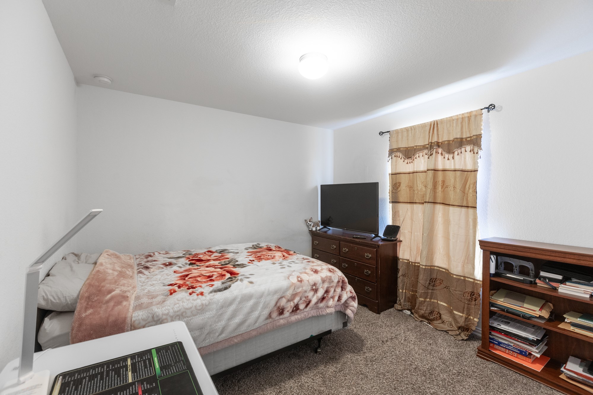 263 Joseph Drive Buda, TX 78610 - Photo 18 of 27 a bedroom with a bed and a television