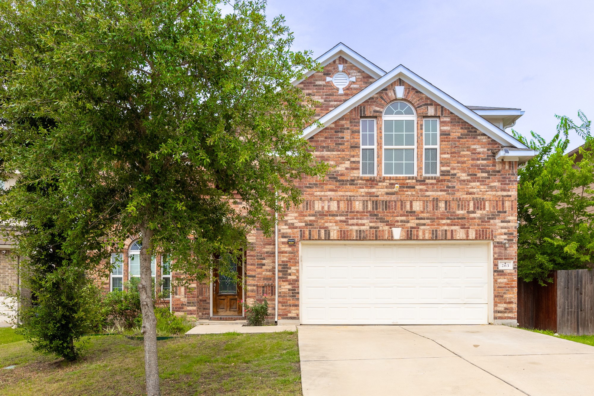 263 Joseph Drive Buda, TX 78610 - Photo 2 of 27 a view of a house with a yard and garage