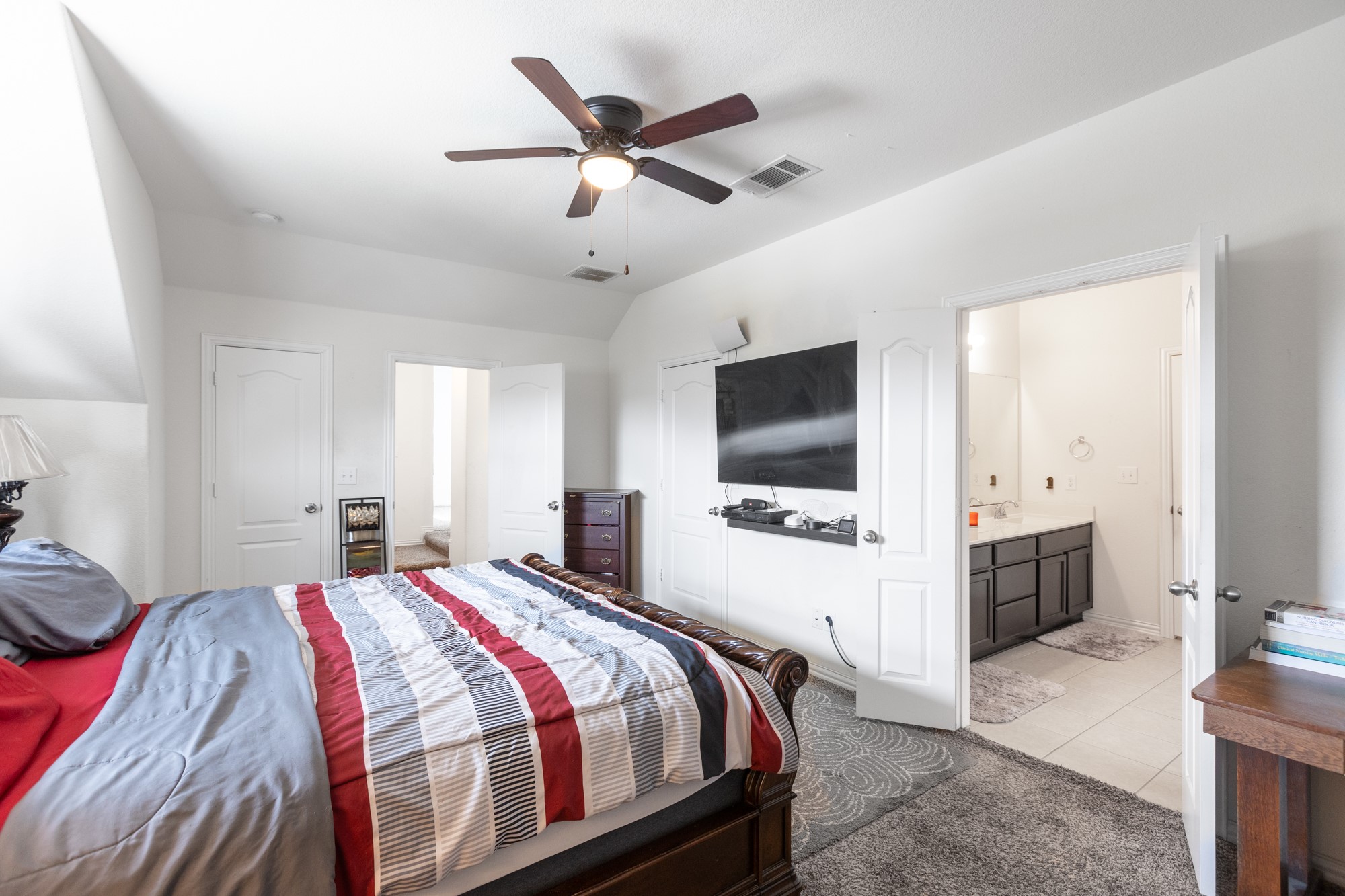 263 Joseph Drive Buda, TX 78610 - Photo 22 of 27 a bedroom with a bed and a flat screen tv