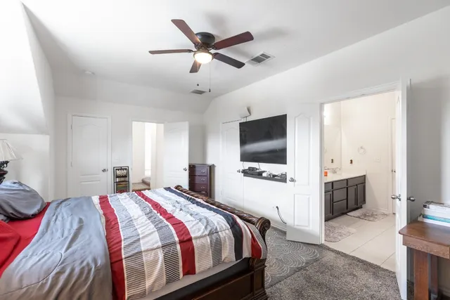 a bedroom with a bed and a flat screen tv