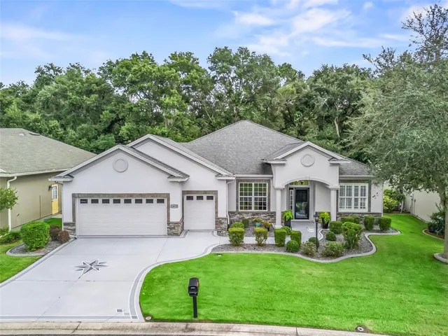 a front view of a house with a yard and porch