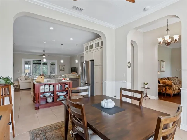a view of a kitchen with stainless steel appliances granite countertop a sink and refrigerator