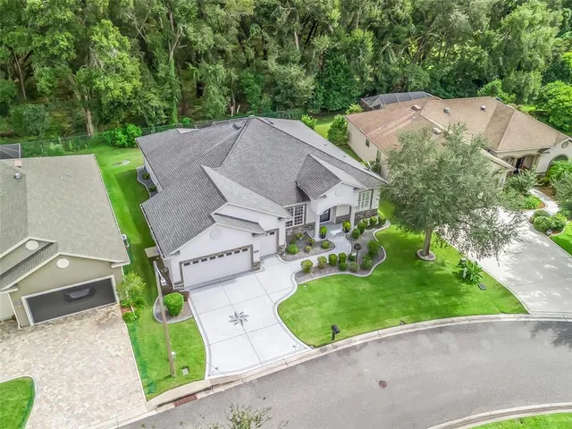 an aerial view of a house with garden space and street view