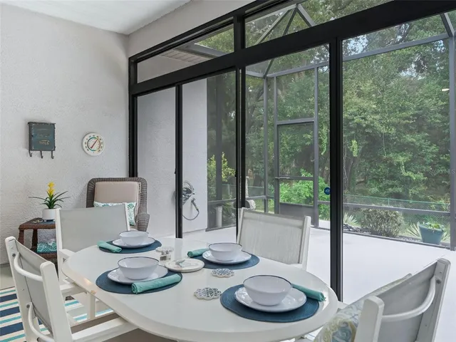a view of a patio with table and chairs potted plants and wooden fence