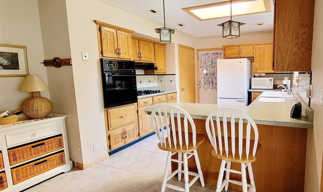 23885 Hazel Road Sterling, IL 61081 - Photo 6 of 48 a kitchen with stainless steel appliances kitchen island granite countertop a refrigerator a stove a sink and white cabinets with wooden floor