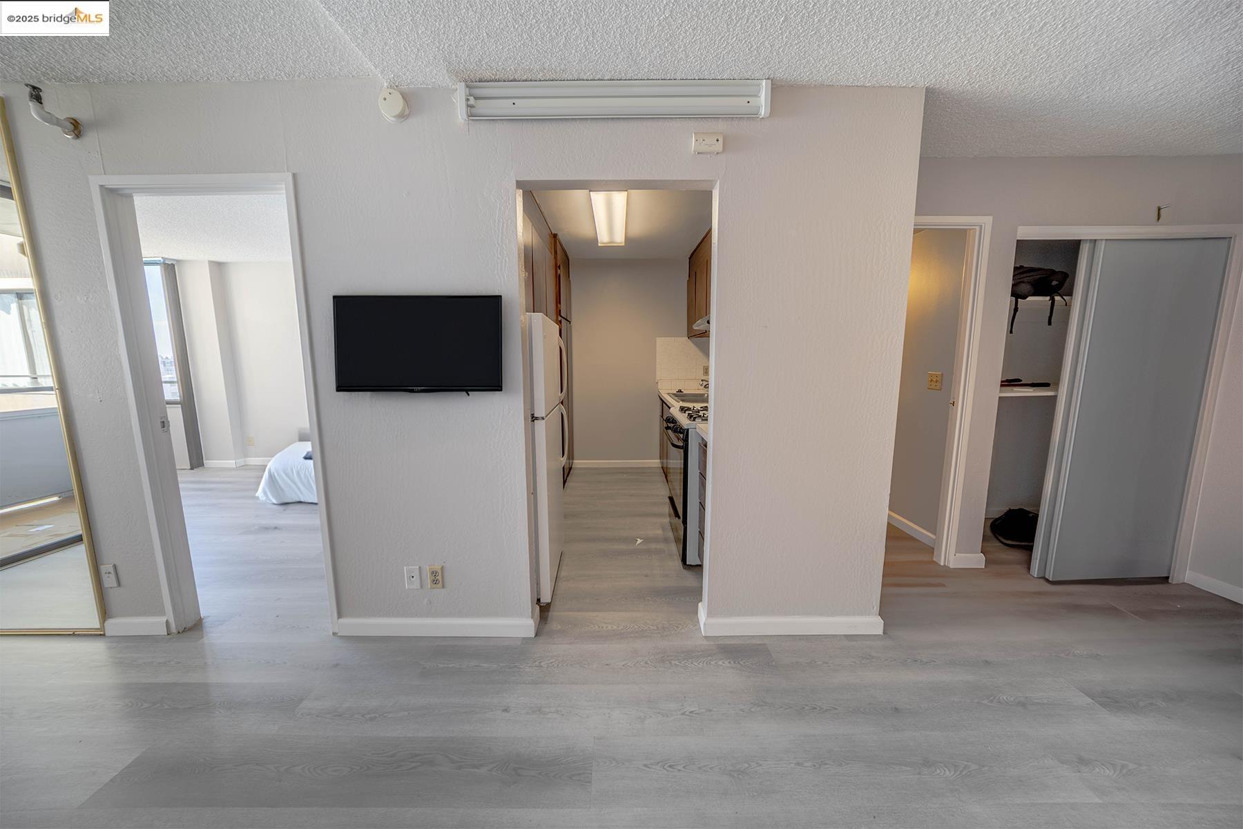 801 Franklin Street, Unit 819 Oakland, CA 94607 - Photo 2 of 9 a view of a livingroom with an empty space and a refrigerator