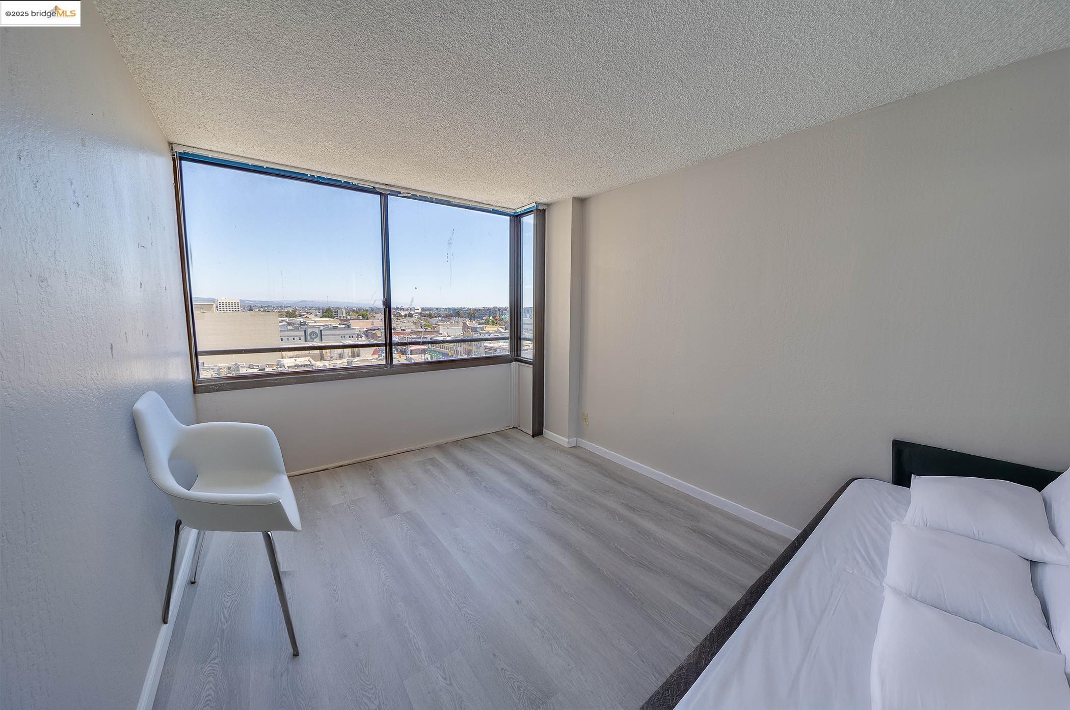 801 Franklin Street, Unit 819 Oakland, CA 94607 - Photo 4 of 9 a view of a room with furniture and a window