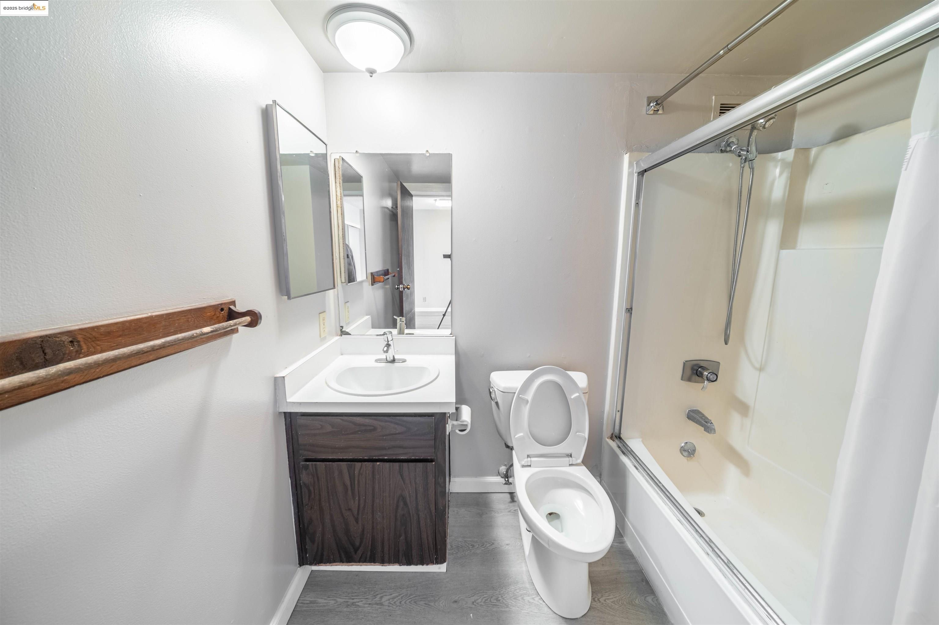 801 Franklin Street, Unit 819 Oakland, CA 94607 - Photo 8 of 9 a bathroom with a sink a toilet and shower