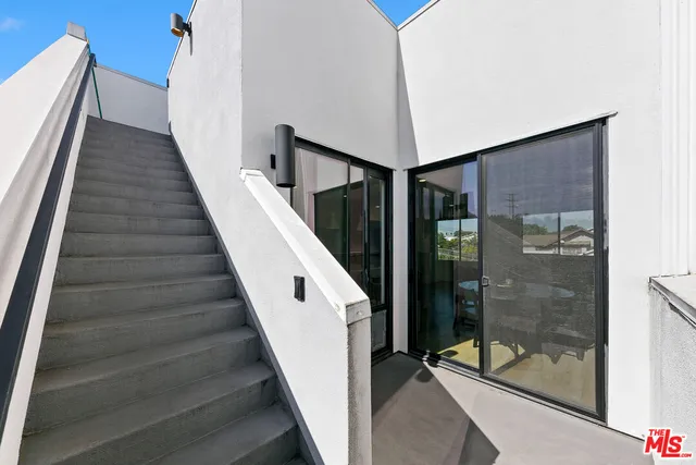 a view of staircase with white walls and shower