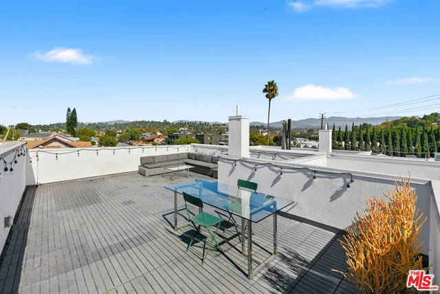 a view of balcony with wooden floor and outdoor seating