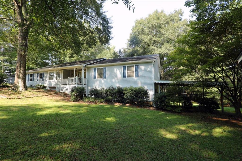 5798 Hill Road Southwest Powder Springs, GA 30127 - Photo 1 of 1 a view of an house with backyard space and garden