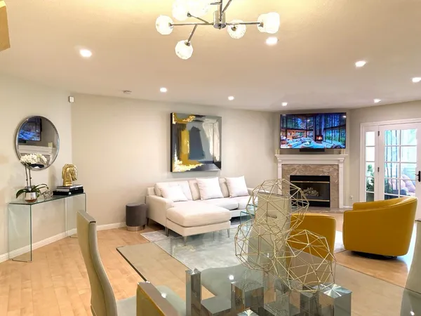 a living room with furniture a fireplace and a flat screen tv