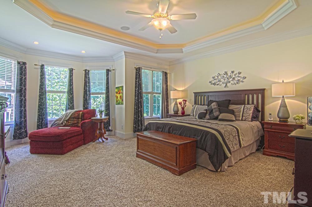 120 Bayleaf Drive Raleigh, NC 27615 - Photo 15 of 25 a bedroom with a bed and glass walk in closet