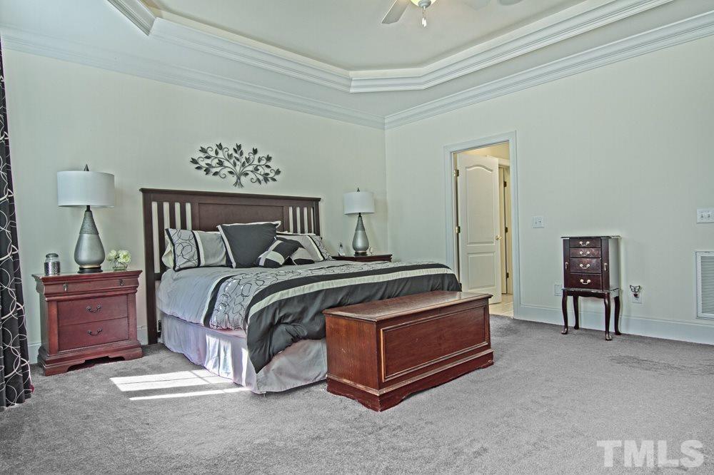 120 Bayleaf Drive Raleigh, NC 27615 - Photo 16 of 25 a bedroom with a bed and a table