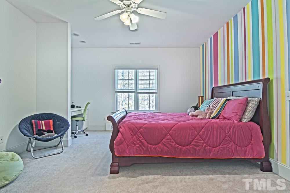 120 Bayleaf Drive Raleigh, NC 27615 - Photo 20 of 25 a bedroom with a bed and a chandelier