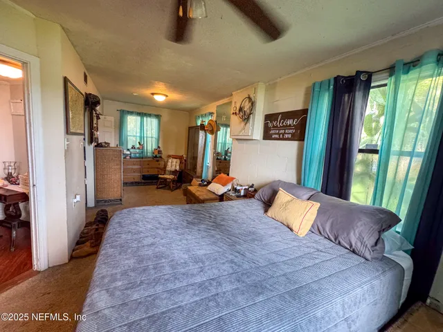 a bedroom with a large bed and a large window