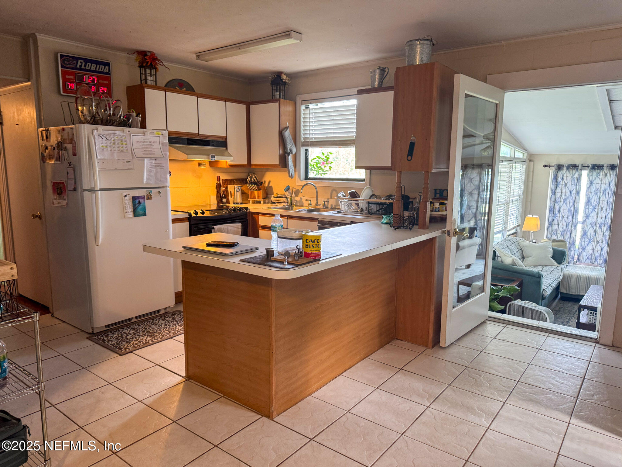 8160 Alderman Road Melrose, FL 32666 - Photo 9 of 15 a kitchen with stainless steel appliances granite countertop a refrigerator a stove and a refrigerator