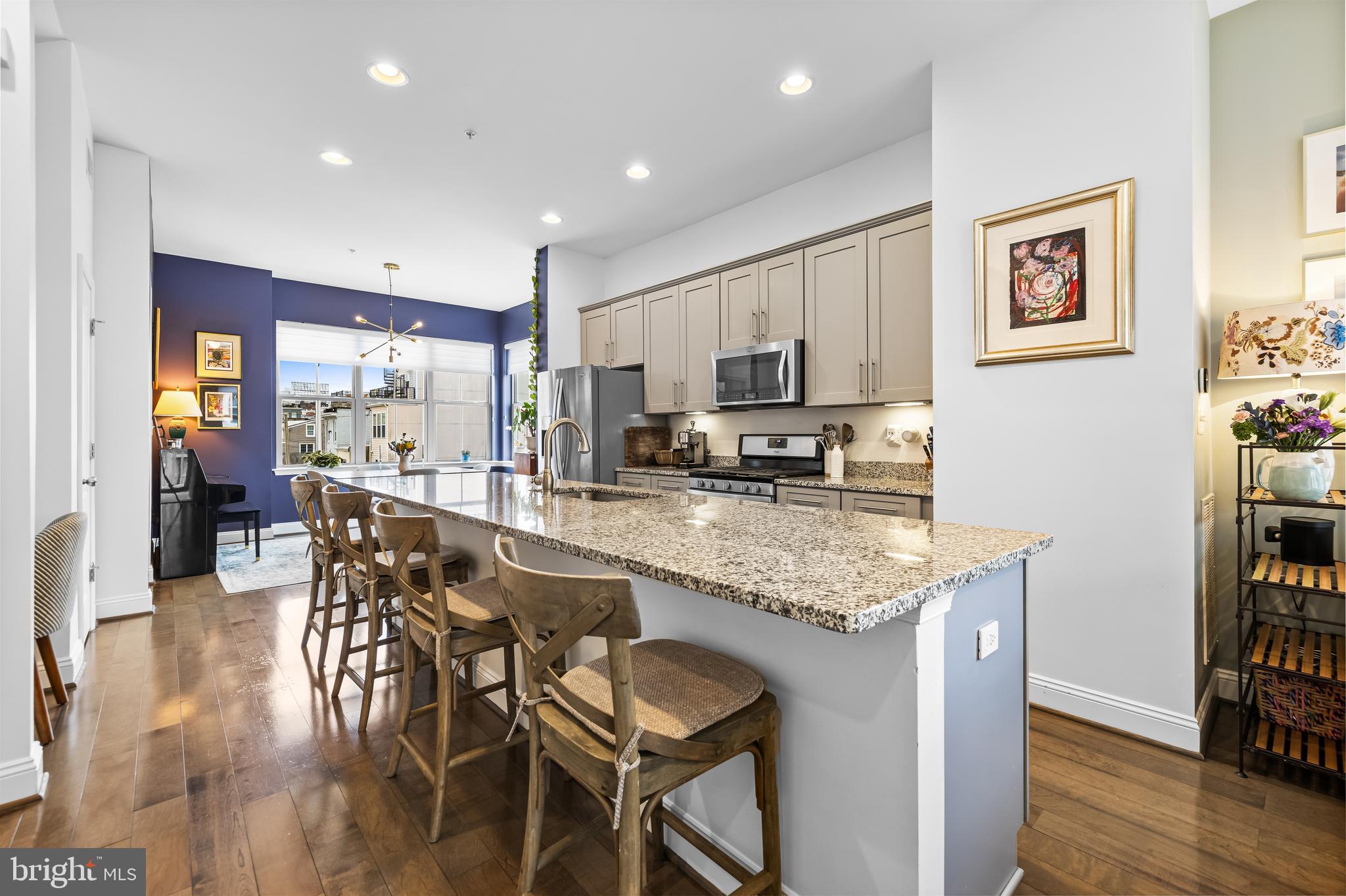 1201 Andre Street Baltimore, MD 21230 - Photo 11 of 39 a kitchen with stainless steel appliances granite countertop a stove top oven a sink a dining table and chairs