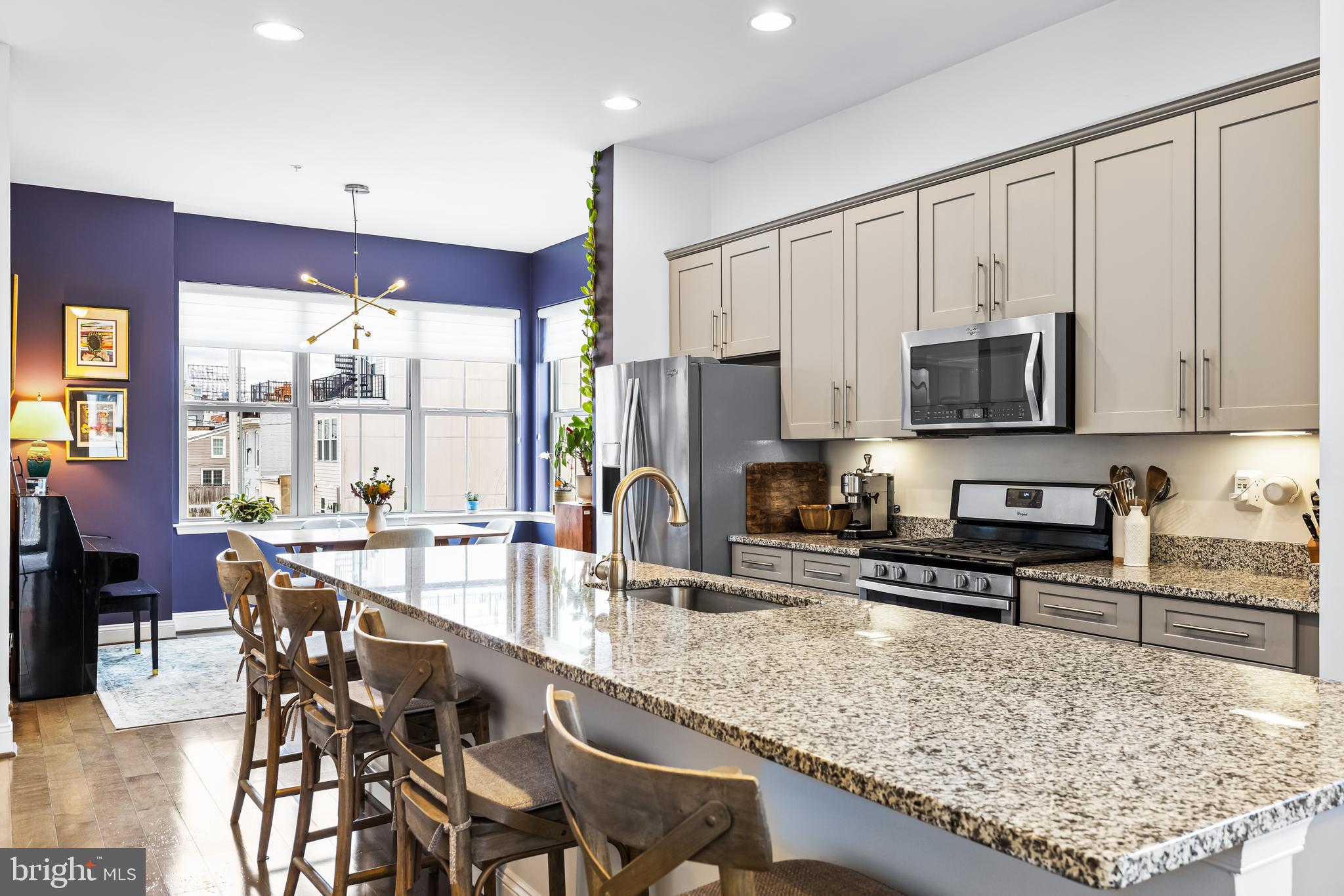 1201 Andre Street Baltimore, MD 21230 - Photo 12 of 39 a kitchen with stainless steel appliances granite countertop a stove top oven a sink a dining table and chairs