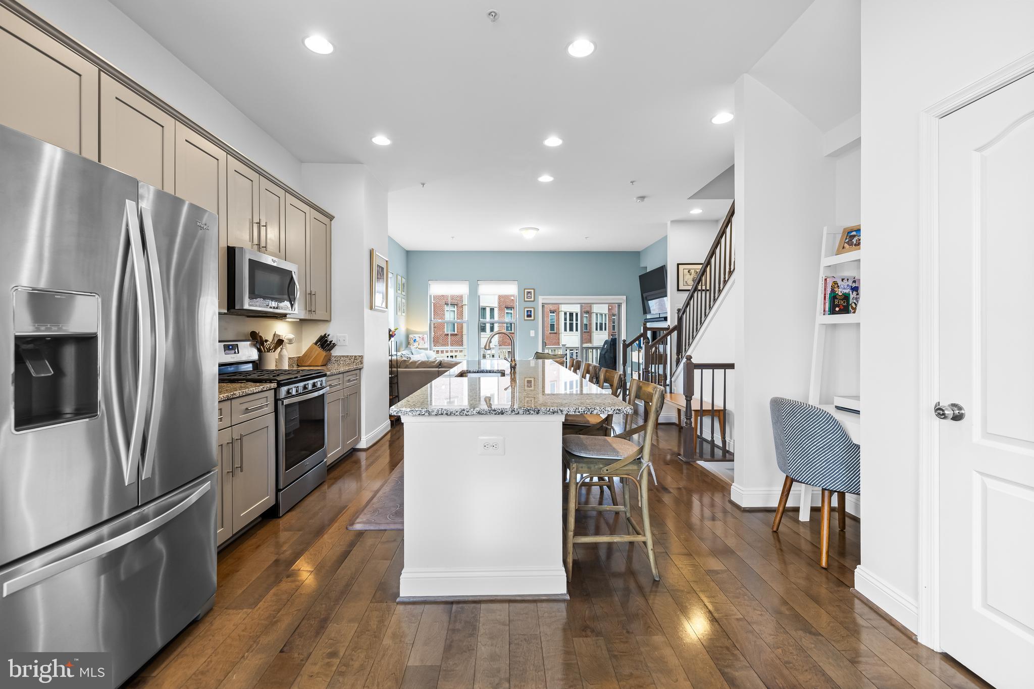 1201 Andre Street Baltimore, MD 21230 - Photo 15 of 39 a kitchen with a refrigerator a dining table and chairs