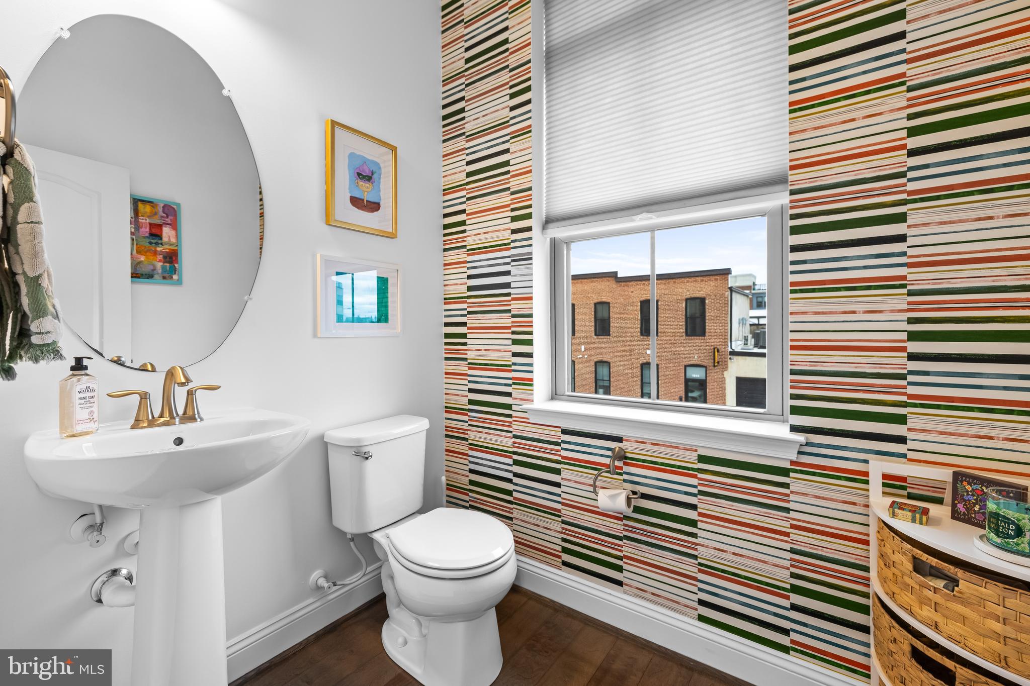 1201 Andre Street Baltimore, MD 21230 - Photo 19 of 39 a bathroom with a sink a toilet and mirror