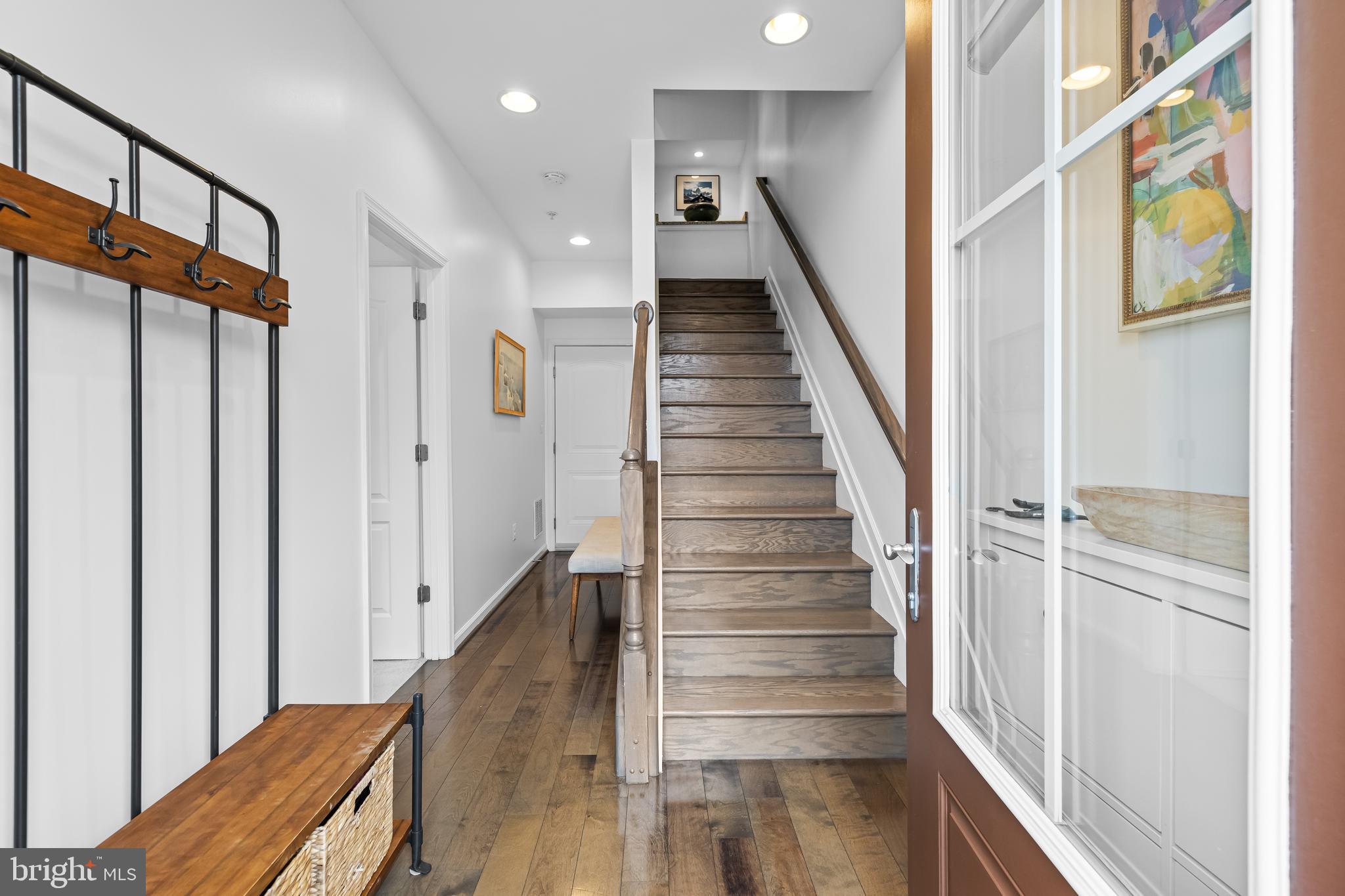 1201 Andre Street Baltimore, MD 21230 - Photo 4 of 39 a view of staircase with lots of frames on wall and wooden floor