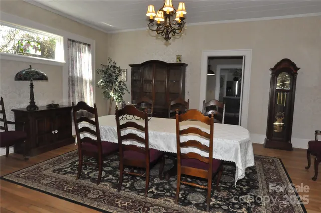 a view of a dining room with furniture and chandelier