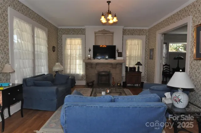 a living room with furniture a fireplace and a flat screen tv