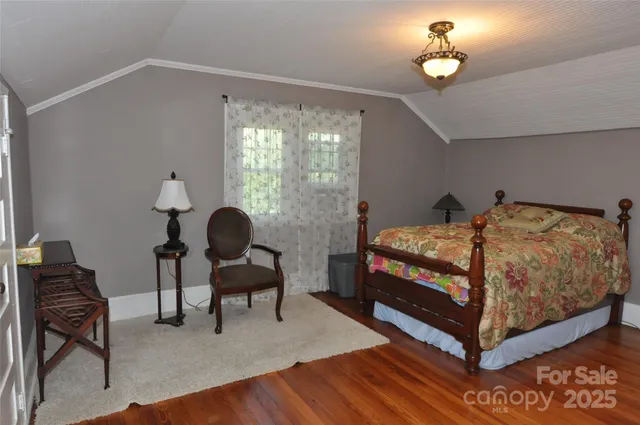 a bedroom with a bed and a chair