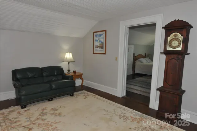 a living room with couch and a wooden floor