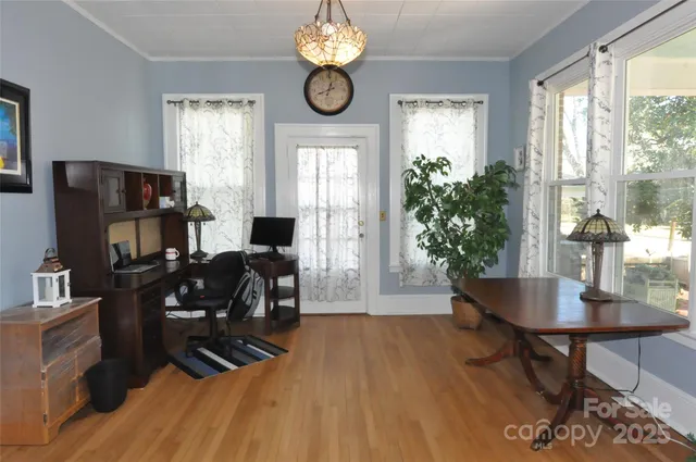 a living room with furniture a large window and a fireplace