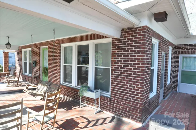 a front view of a house with outdoor seating