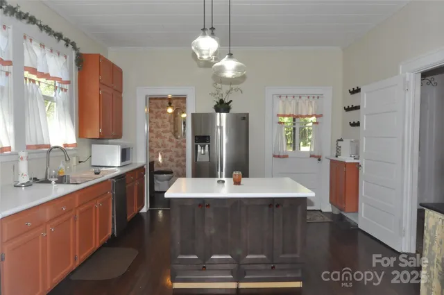 a spacious bathroom with a granite countertop sink a toilet a mirror and shower