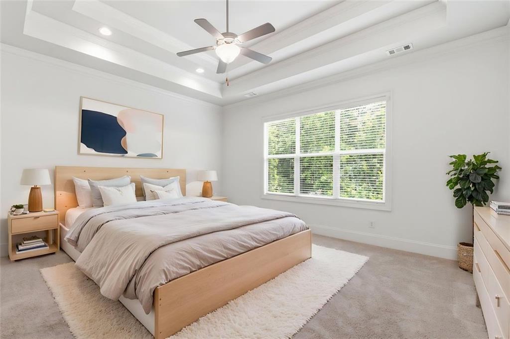 337 Rosshandler Road Suwanee, GA 30024 - Photo 20 of 45 a spacious bedroom with a large bed and a window