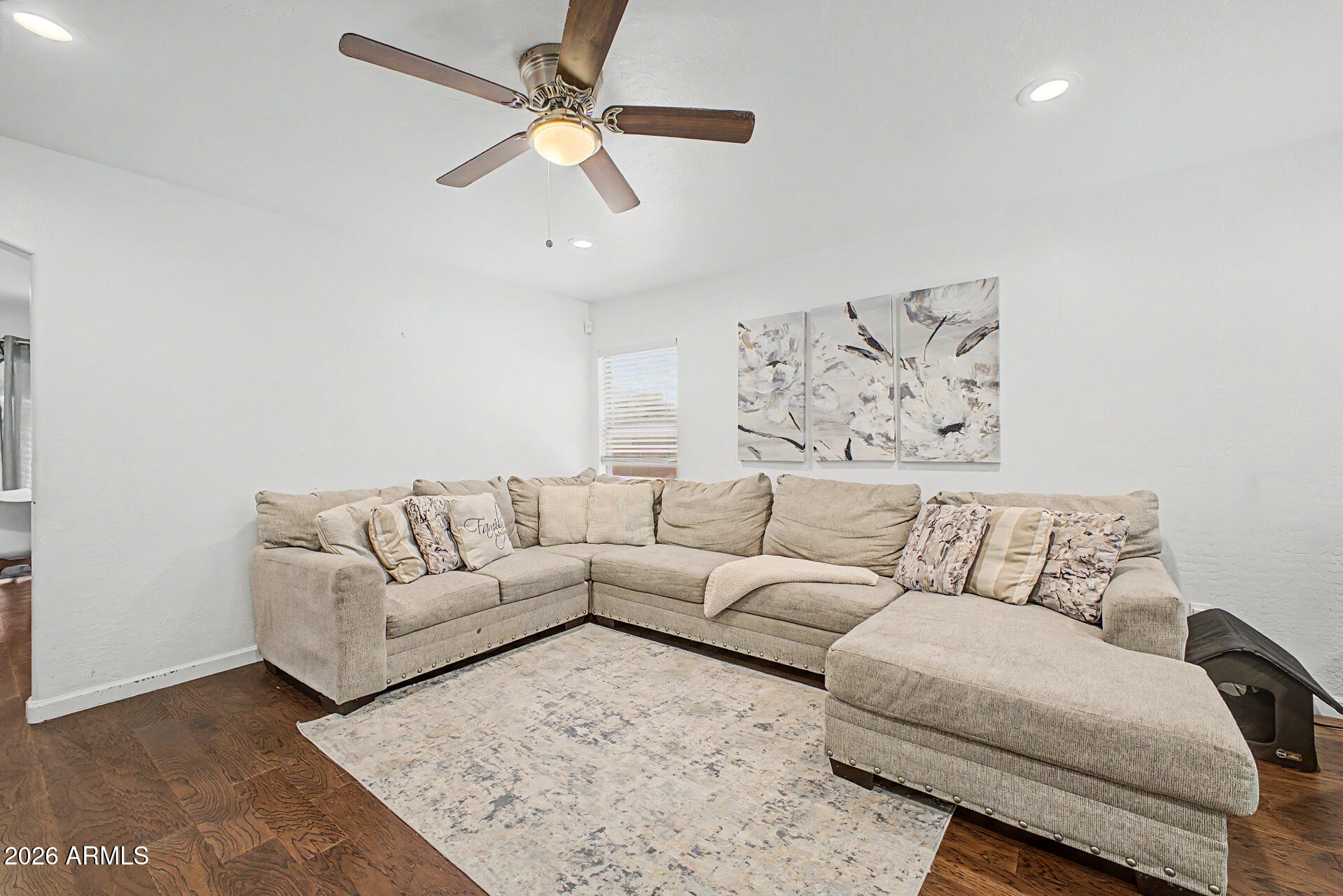 12008 West Larkspur Road El Mirage, AZ 85335 - Photo 3 of 25 a living room with furniture and a ceiling fan
