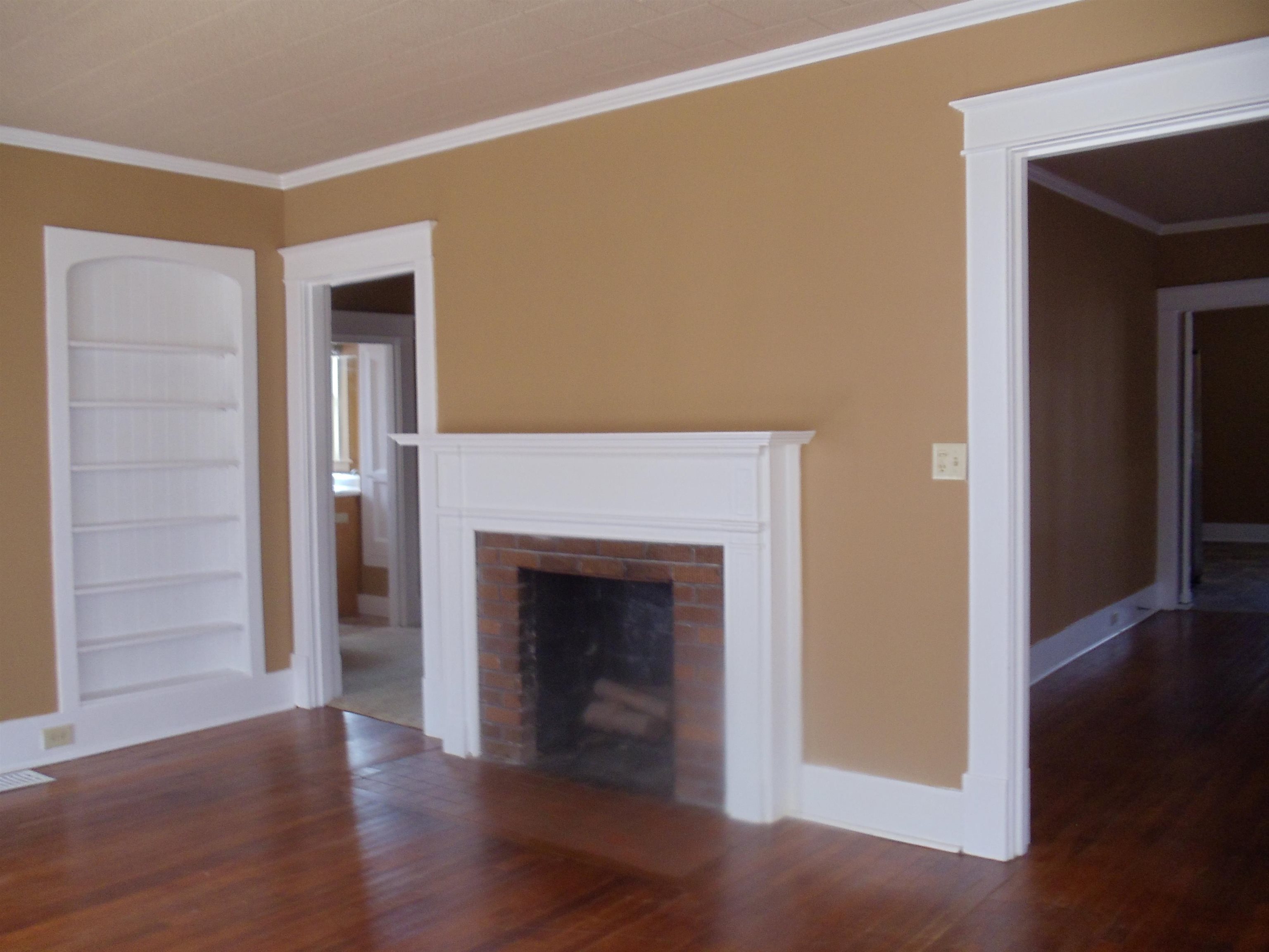 262 Lake Drive Ripley, TN 38063 - Photo 2 of 25 a view of an empty room with wooden floor and a fireplace