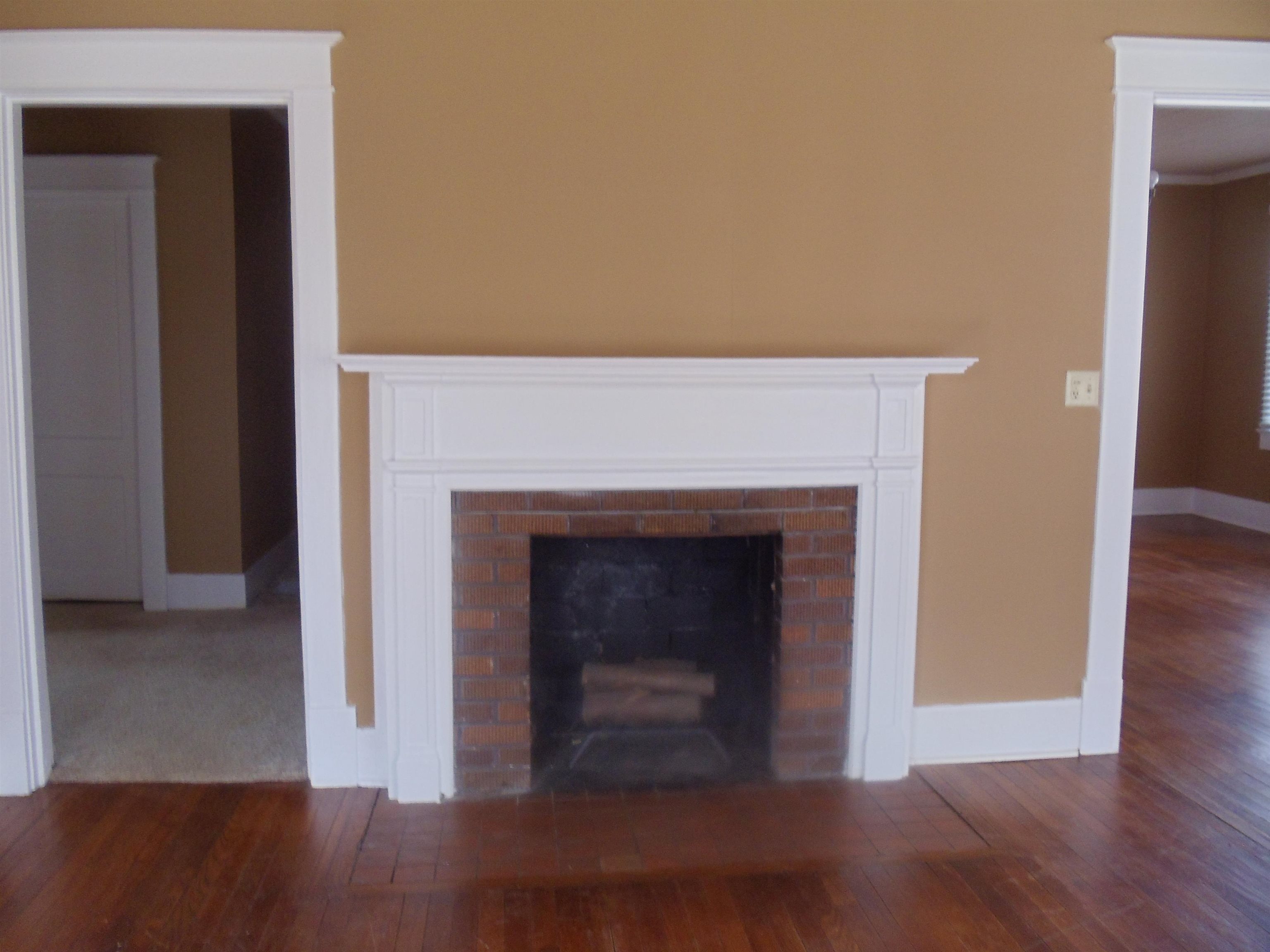 262 Lake Drive Ripley, TN 38063 - Photo 5 of 25 a view of an empty room with wooden floor and a fireplace