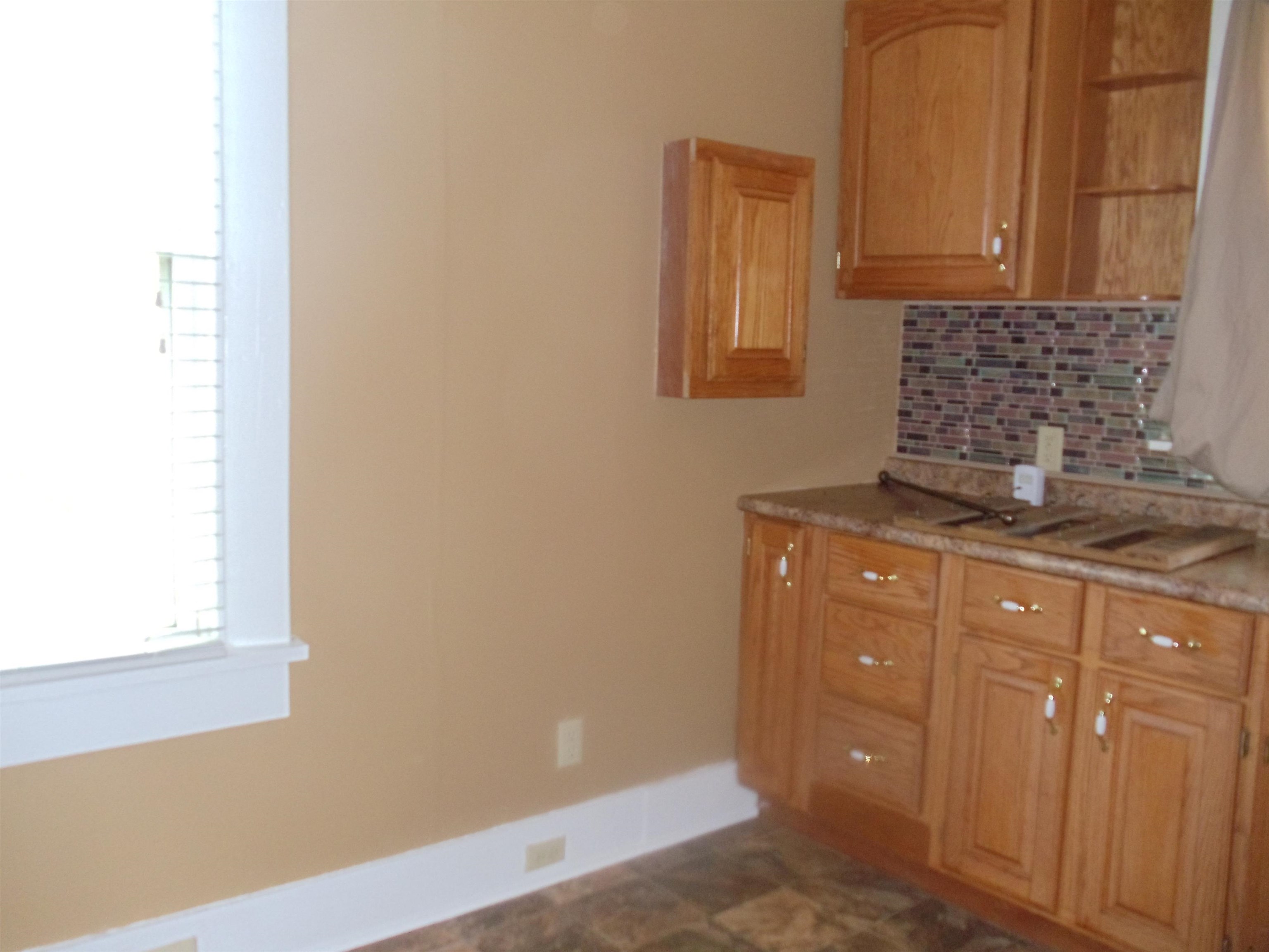 262 Lake Drive Ripley, TN 38063 - Photo 8 of 25 a kitchen with granite countertop white cabinets and stainless steel appliances